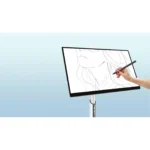 A hand holding a stylus drawing on a digital tablet displaying a sketch of a woman's face.